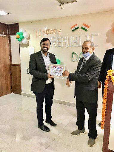 Dr. Umesh Kumar receiving an award